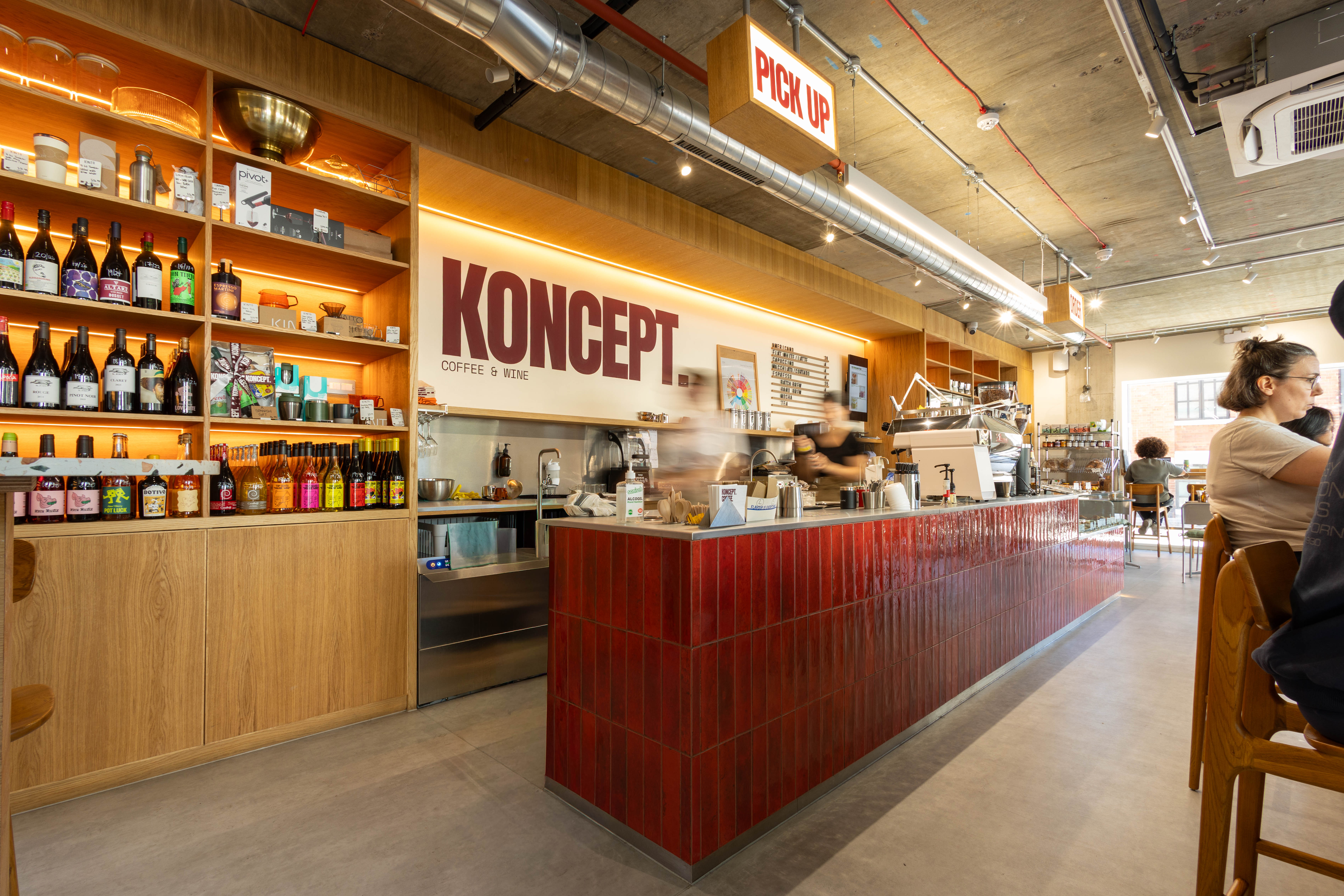 The counter run and oak display wall at Koncept Coffee & Wine, a café fit-out by K&K Studio