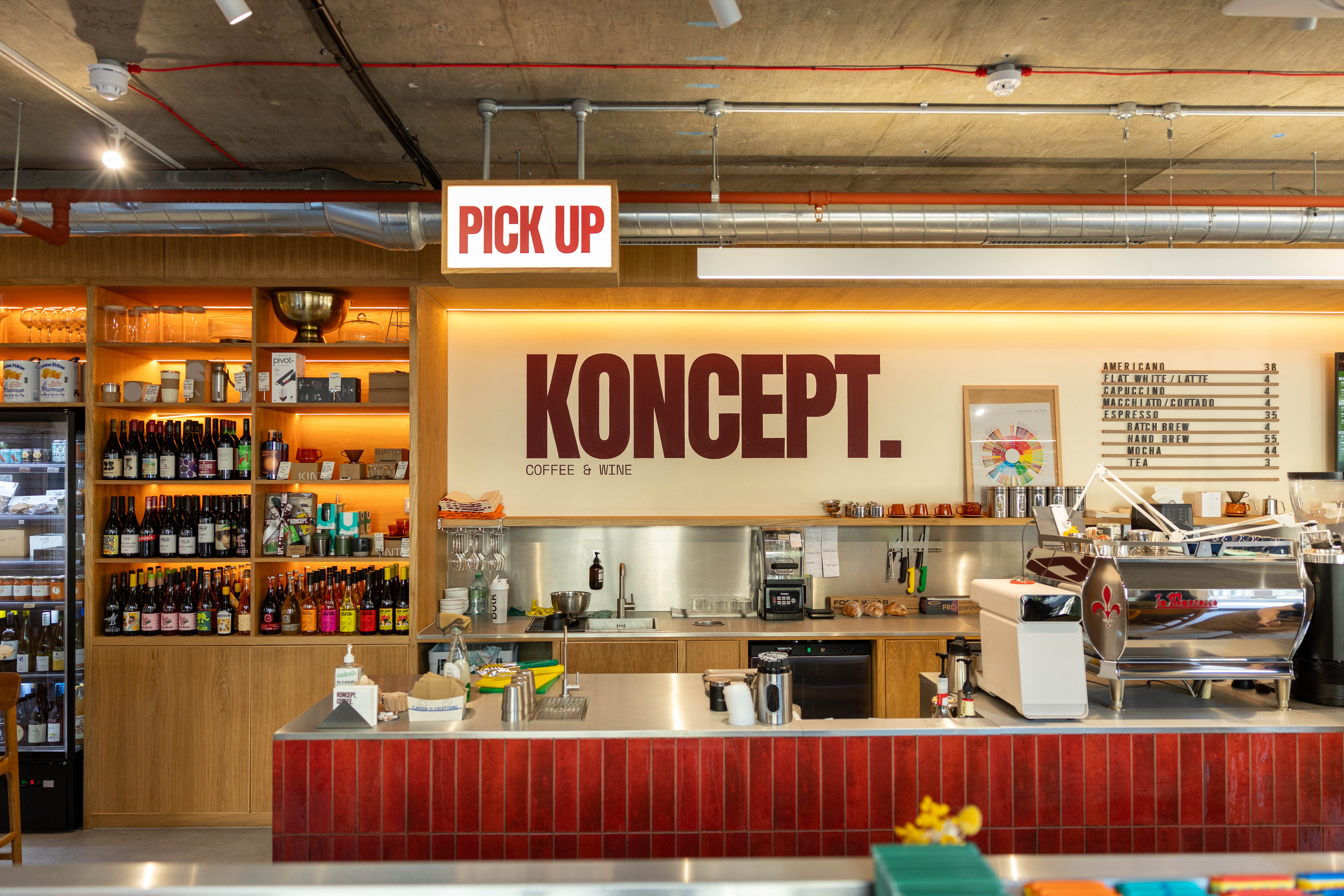 The red-tiled counter, plywood shelving and menu board at Koncept Coffee & Wine