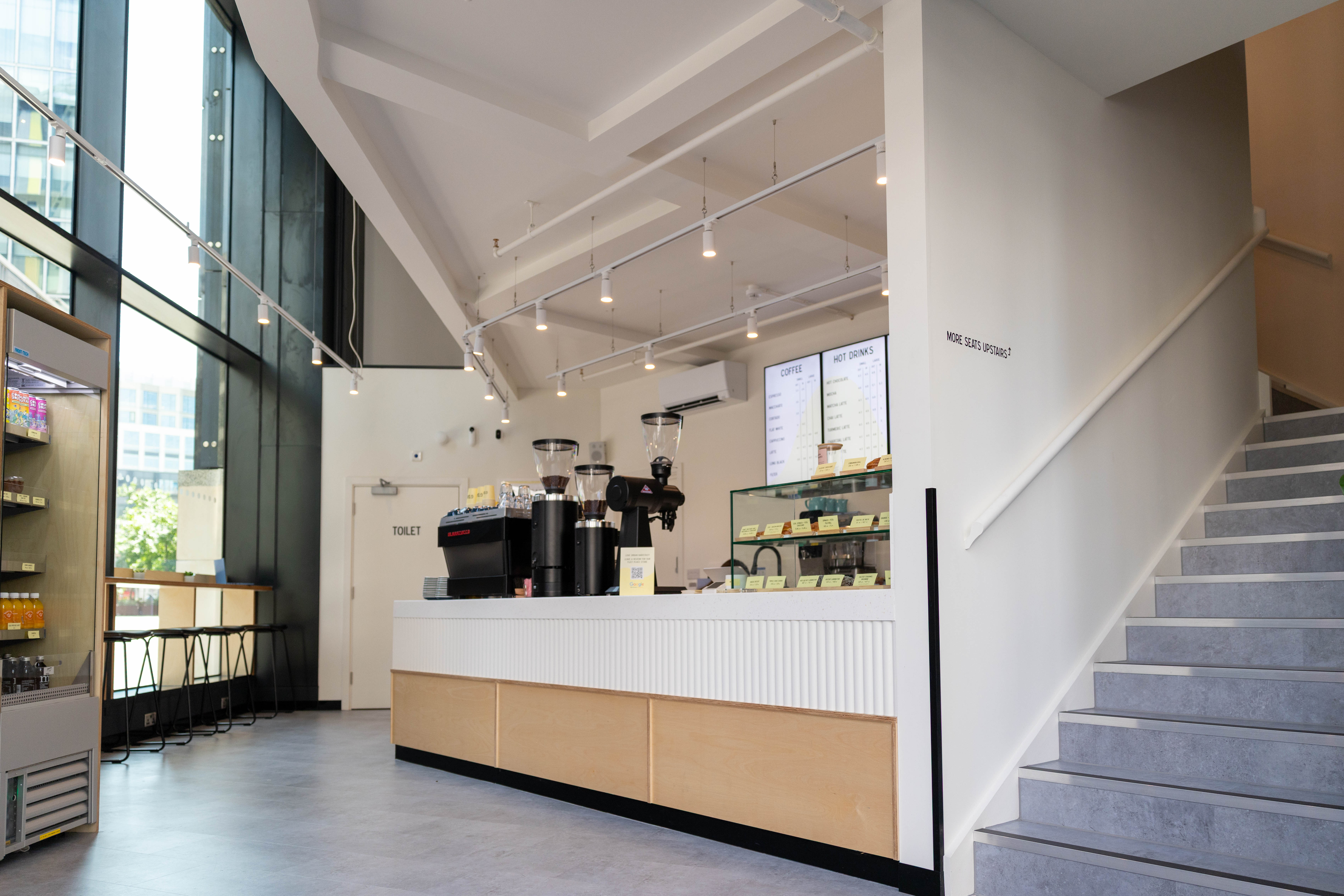 The counter, display case and stair at Urban Baristas, Fleet Place